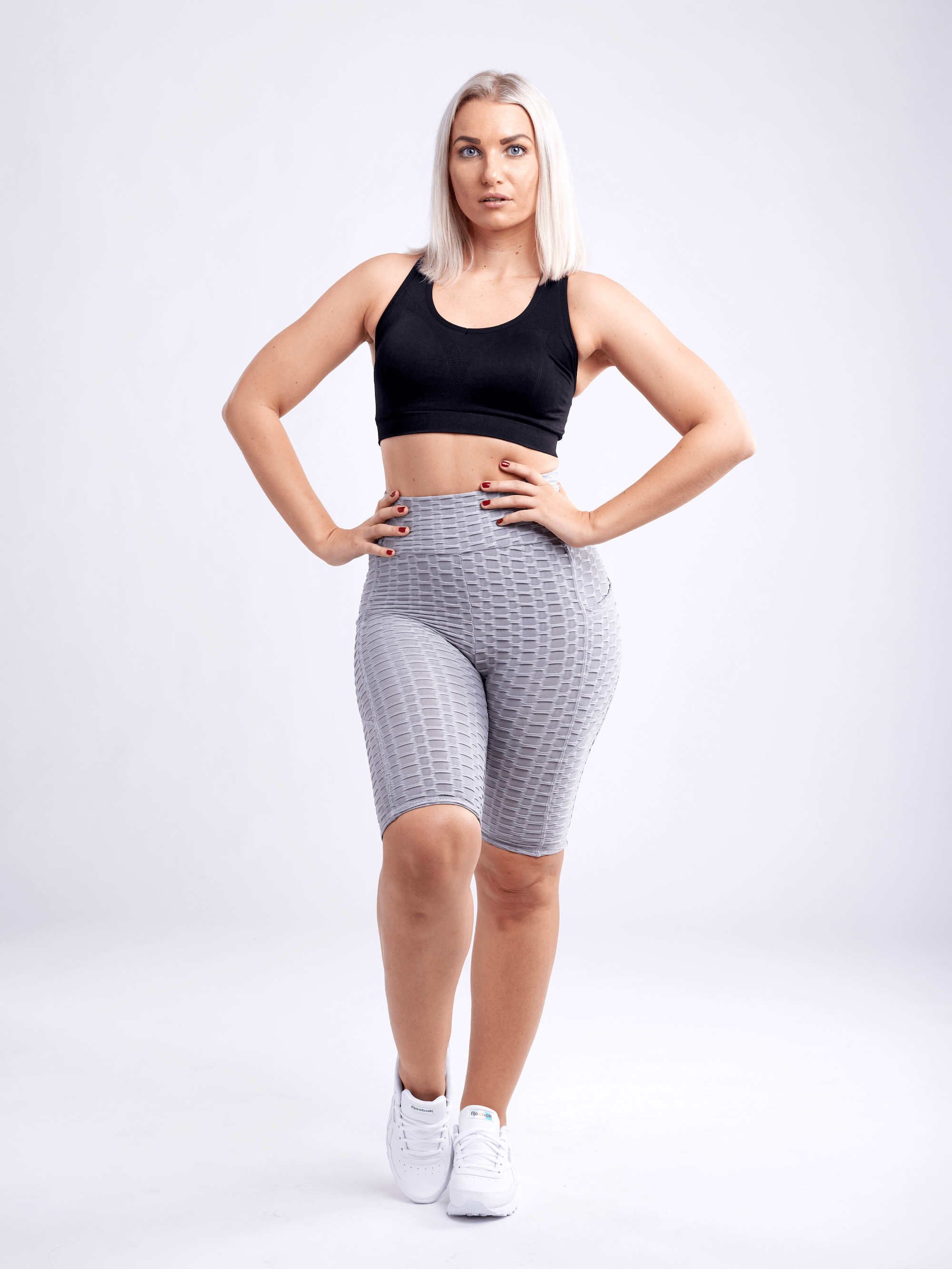 Black Lavender JupiterGear high-waisted scrunch yoga shorts with hip pockets, shown on a model, emphasizing fit and activewear design.