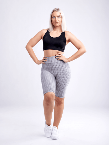 Black Lavender JupiterGear high-waisted scrunch yoga shorts with hip pockets, shown on a model, emphasizing fit and activewear design.