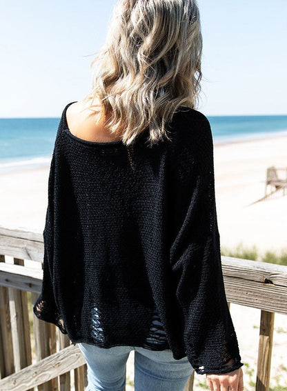 Black distressed boxy fit crop knit sweater by Harlequin Daisy, showing textured fabric and stylish cropped design.