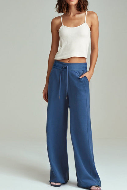 Sail blue Carmine Juneberry high waist wide-leg sweatpants with drawstrings and side pockets, made from comfortable fabric.