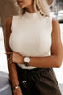 White ribbed knit high neck sweater vest by Carmine Juneberry, featuring a fitted design and cozy high neckline.