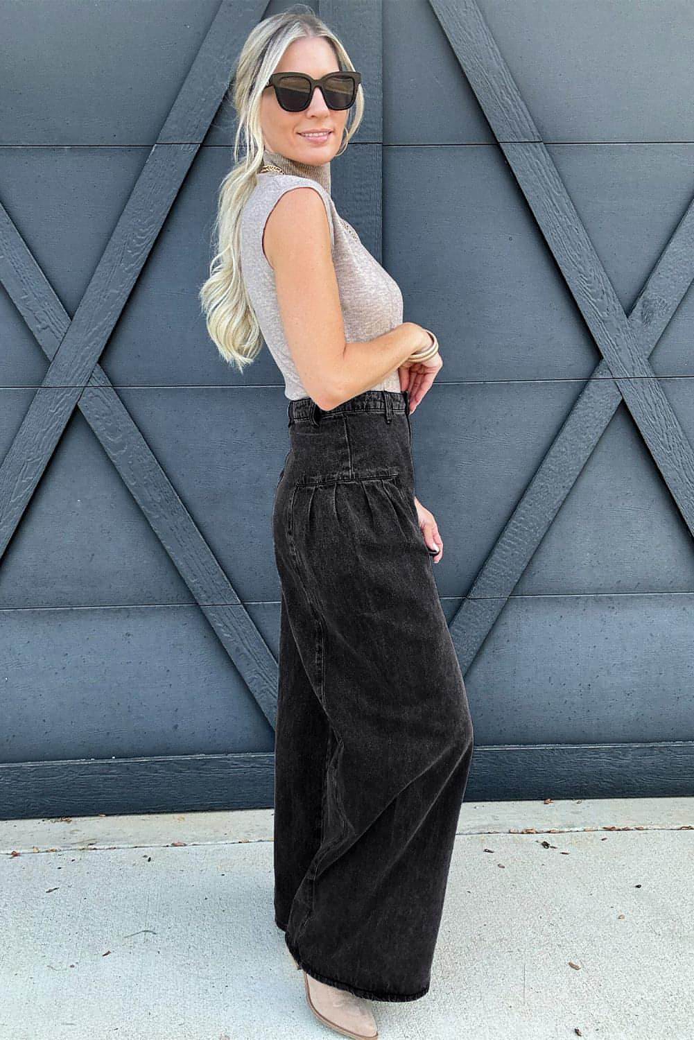 Dark grey pleated wide-leg denim pants by Carmine Juneberry with mineral wash finish, featuring a relaxed fit and stylish design.