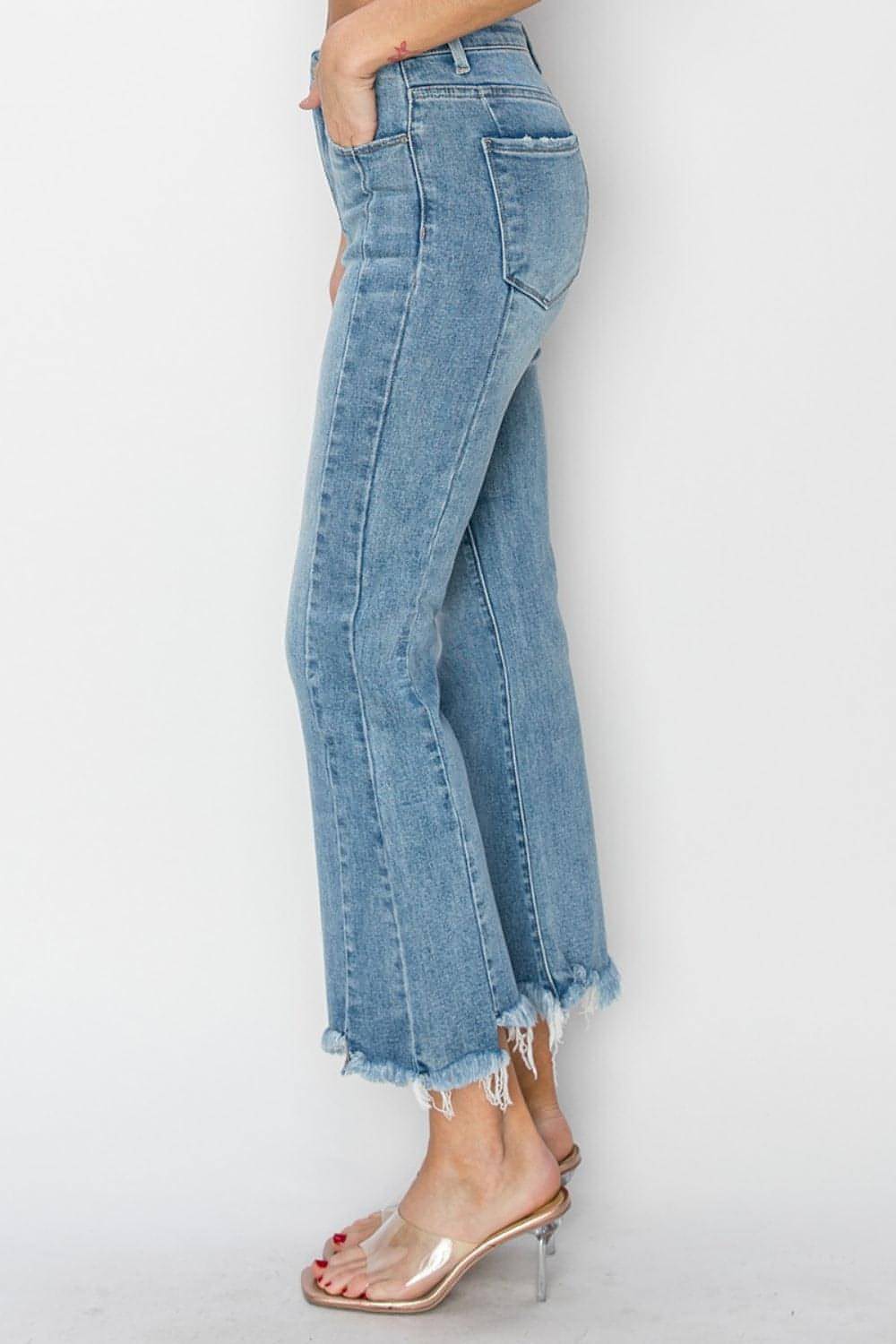 Carmine Juneberry Risen full-size high-rise flare jeans with frayed hem and classic denim wash, displayed on a hanger.