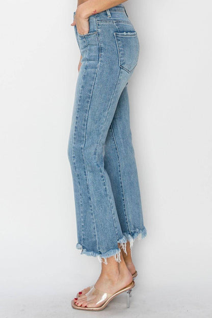 Carmine Juneberry Risen full-size high-rise flare jeans with frayed hem and classic denim wash, displayed on a hanger.