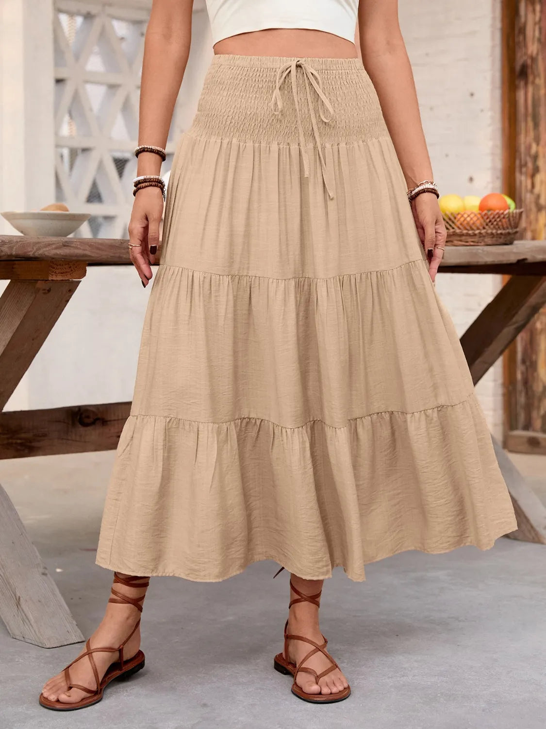 Rust-colored smocked tiered skirt for women by Ruby Styx, featuring a flowy, layered design and elastic waistband.
