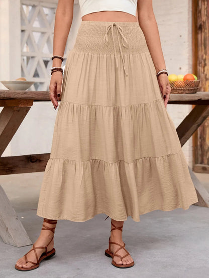 Rust-colored smocked tiered skirt for women by Ruby Styx, featuring a flowy, layered design and elastic waistband.