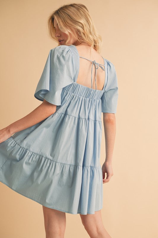 Aemi + Co square neck half sleeve tiered dress in automotive style, featuring layered fabric and a modern design by Jade Icarus.