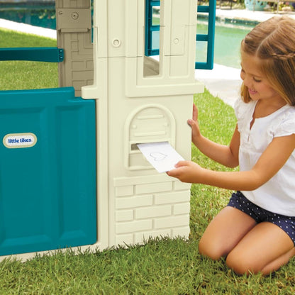 Large blue cottage playhouse for kids, outdoor furniture by Peach Maple, featuring windows and a charming design for outdoor play.