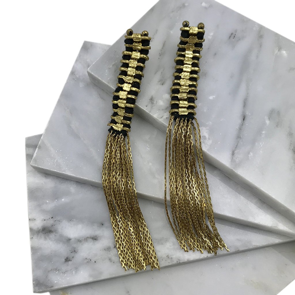 Gold tassel earrings by Ariel featuring elegant temple-inspired design with delicate tassels for stylish wear.