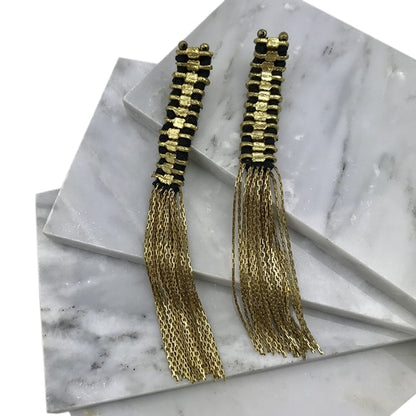 Ariel Temple Tassel Earrings featuring gold tassels hanging from delicate earring hooks, showcasing intricate craftsmanship.