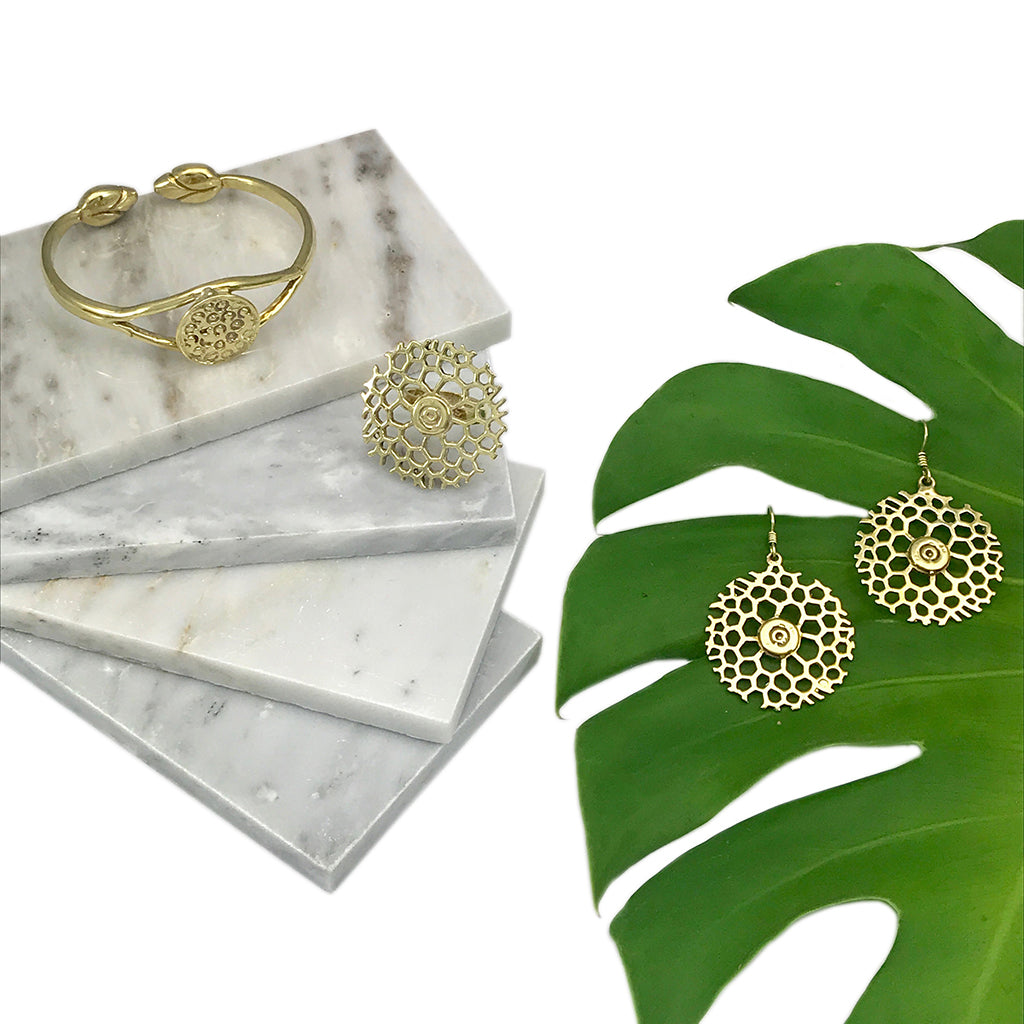 Ariel Bombshell Lotus Cuff jewelry made of fair-trade recycled brass, featuring an intricate lotus design on the wrist.