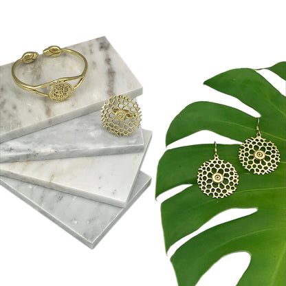Ariel Bombshell Lotus Cuff jewelry made of fair-trade recycled brass, featuring an intricate lotus design on the wrist.