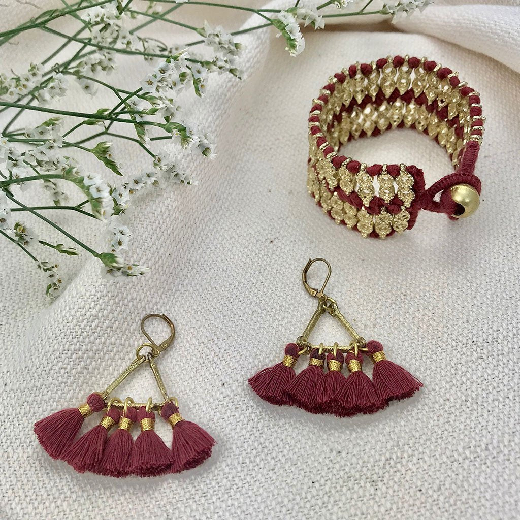 Ariel Lola Fan earrings with red tassels and gold accents, hanging jewelry piece in a fair-trade design, showcasing elegant craftsmanship.
