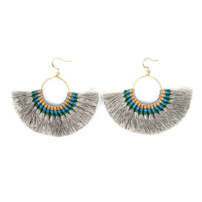A pair of colorful silk tassel fan earrings by Ariel, featuring vibrant tassels hanging from gold-tone hooks.