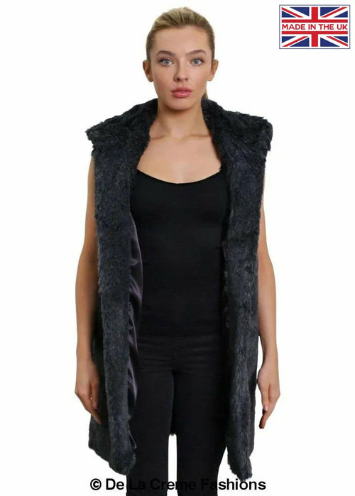 Grey faux fur hooded gilet by Rose Eleusis, stylish sleeveless jacket with plush fur hood, perfect for layered winter fashion.