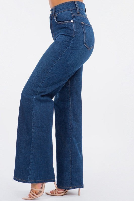 Dark blue Olivia wide leg jeans by Jade Icarus, featuring a high waist and relaxed fit with visible stitching and pockets.