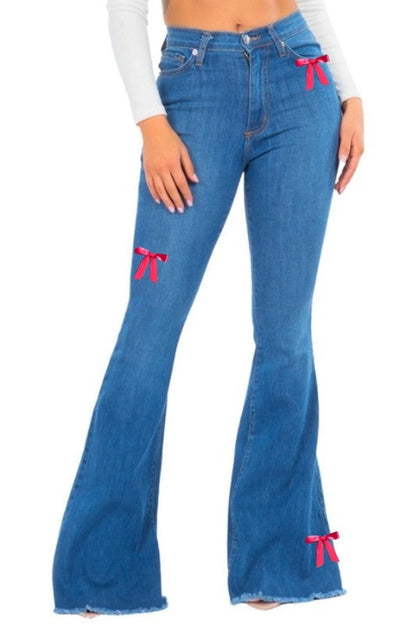 Jade Icarus bell bottom jean with pink ribbon detail, showcasing vibrant fabric and stylish retro-inspired design.