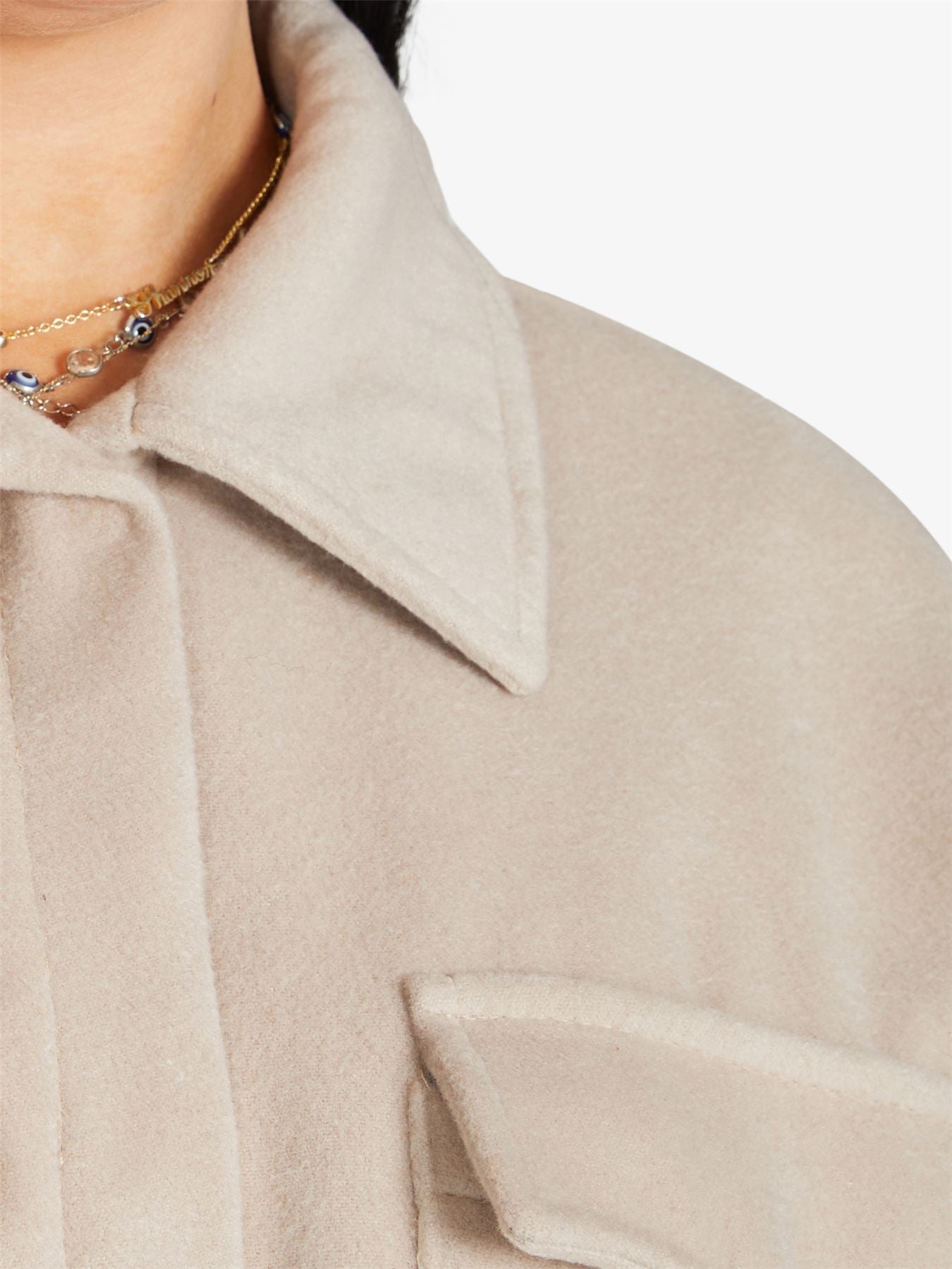 Oversized longline shacket by Rose Eleusis, featuring a relaxed fit, button front, and layered coat style in neutral fabric.