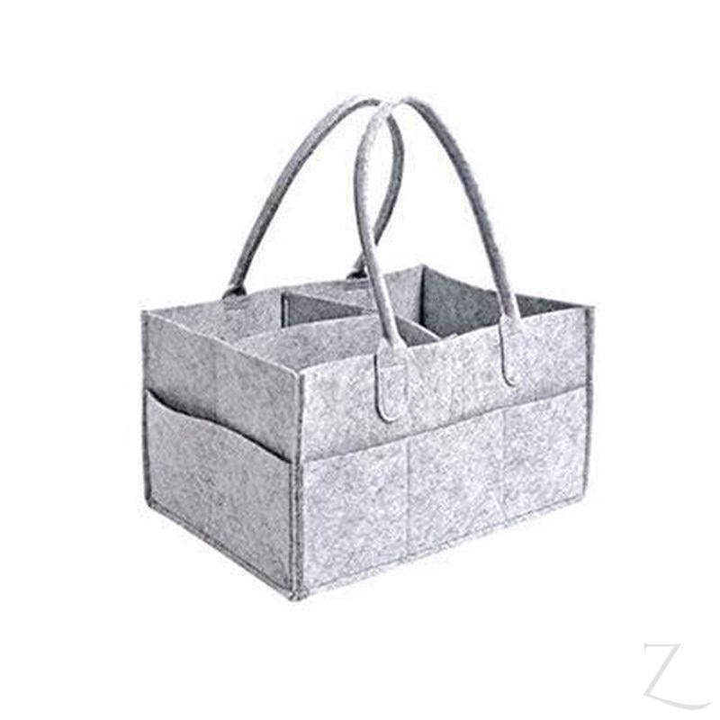 Grey felt nappy organizer caddy by Raspberry Pallas, with multiple compartments for baby essentials on a neutral background.