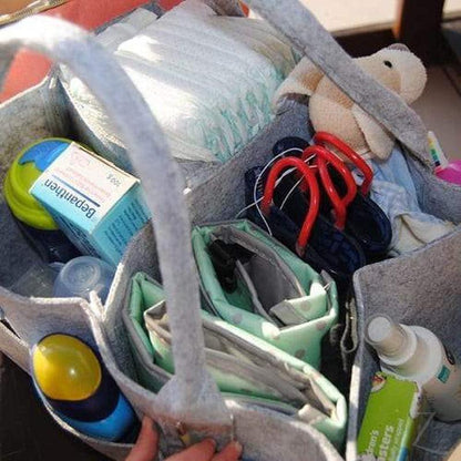 Grey felt nappy organizer caddy by Raspberry Pallas with multiple compartments for baby essentials.