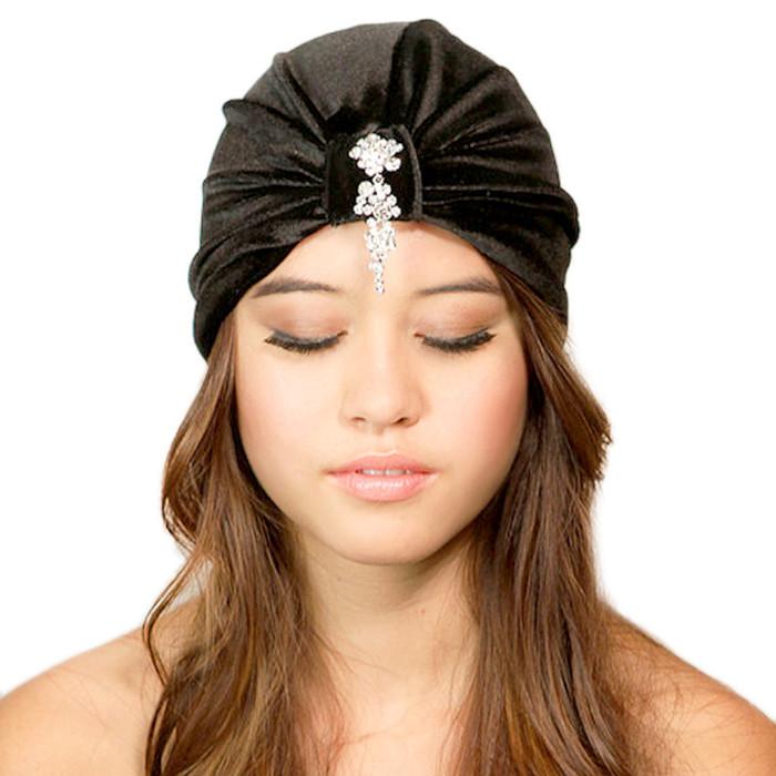 Fiona wearing Cyan Ismene Cascading Crystals Turban hat with layered crystal embellishments and elegant fabric design.