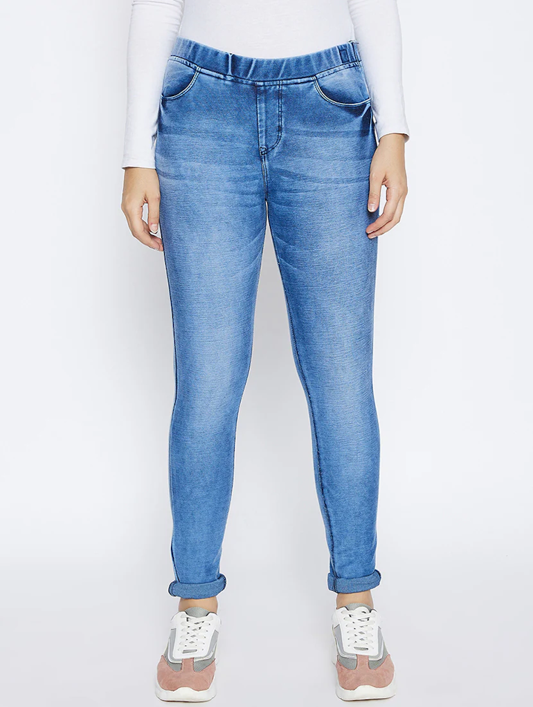 Women’s high rise blue denim jeans by Ochre Ourea, size 28, displayed on a hanger with visible stitching and classic five-pocket design.