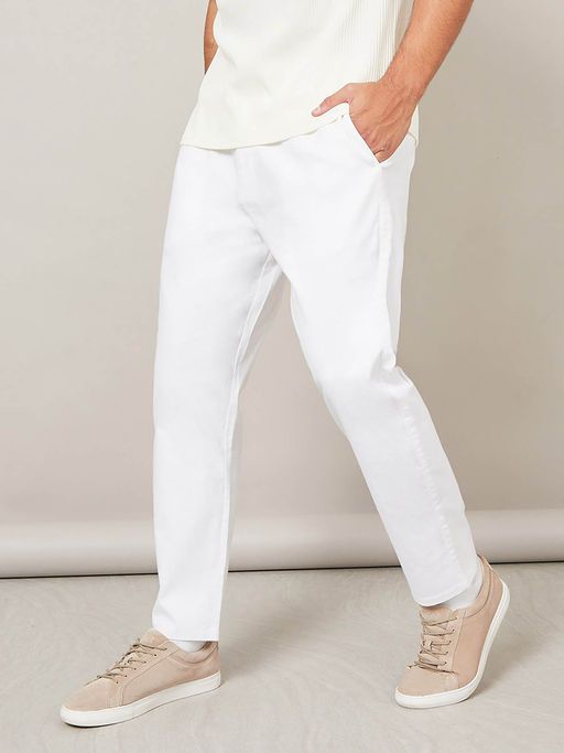 White cotton linen trousers for men by Yellow Caeneus, featuring a relaxed fit and stylish design.