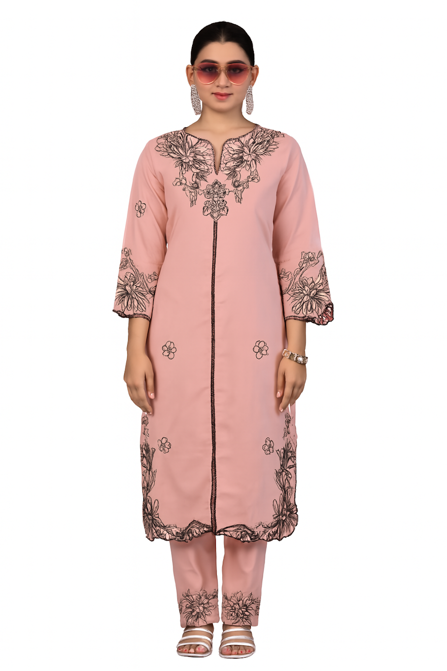 Women’s pink traditional embroidery kurta set with jewelry accessories, showcasing intricate needlework and vibrant fabric details.