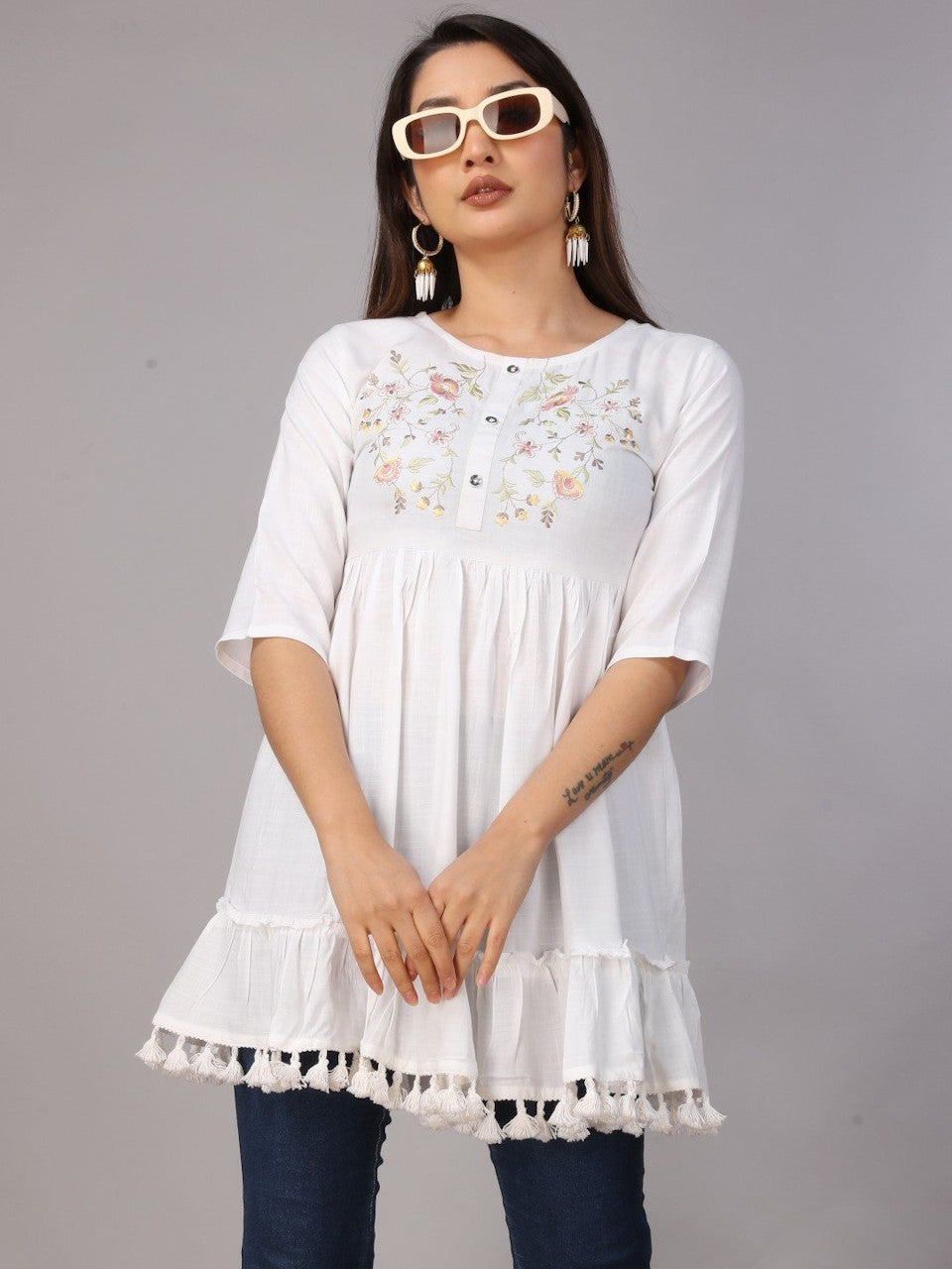 Women’s white embroidered fit and flare rayon tunic by Raspberry Abderus, showing intricate embroidery and flowing fit.