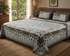 Printed bedsheet with fade-resistant fabric from Amber Cronus, showing a colorful floral design on a neatly made bed.