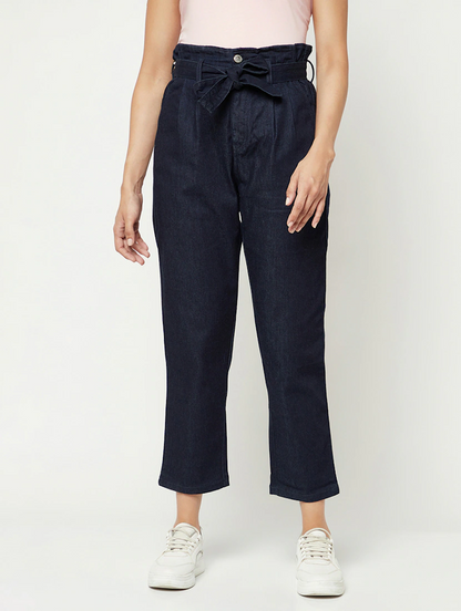 Women’s high rise navy blue denim jeans by Ochre Ourea, size 28, shown on a model with front pockets and a fitted waist.