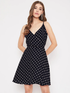Black women’s V-neck polka dot printed A-line dress by Pear Summer Lilac, size L, showcased on a model.