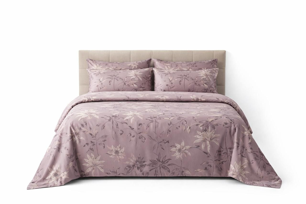 Soft floral mauve bedding set by Violet Achilles with delicate flower patterns on plush fabric for cozy bedroom decor.