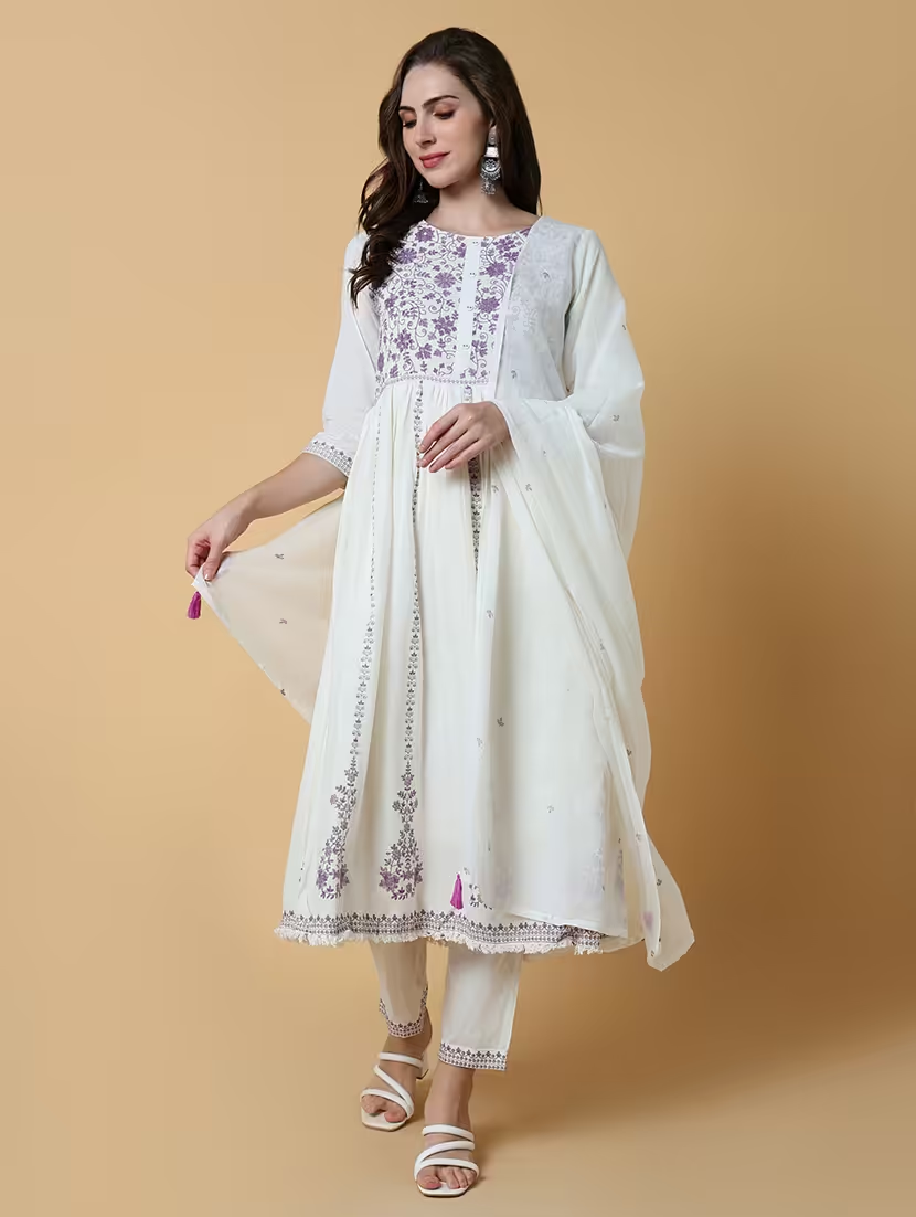 Women’s embroidered suit set in white by Viridian Pontus, featuring intricate embroidery on the top and matching bottoms.
