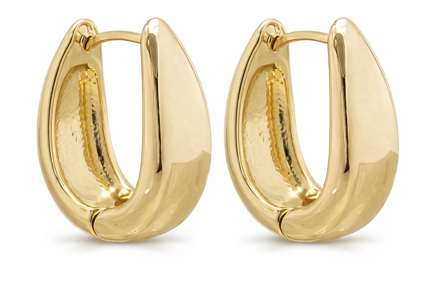 Gold hoop earrings for women by Erin Metis, showing close-up of shiny, circular earrings on model&