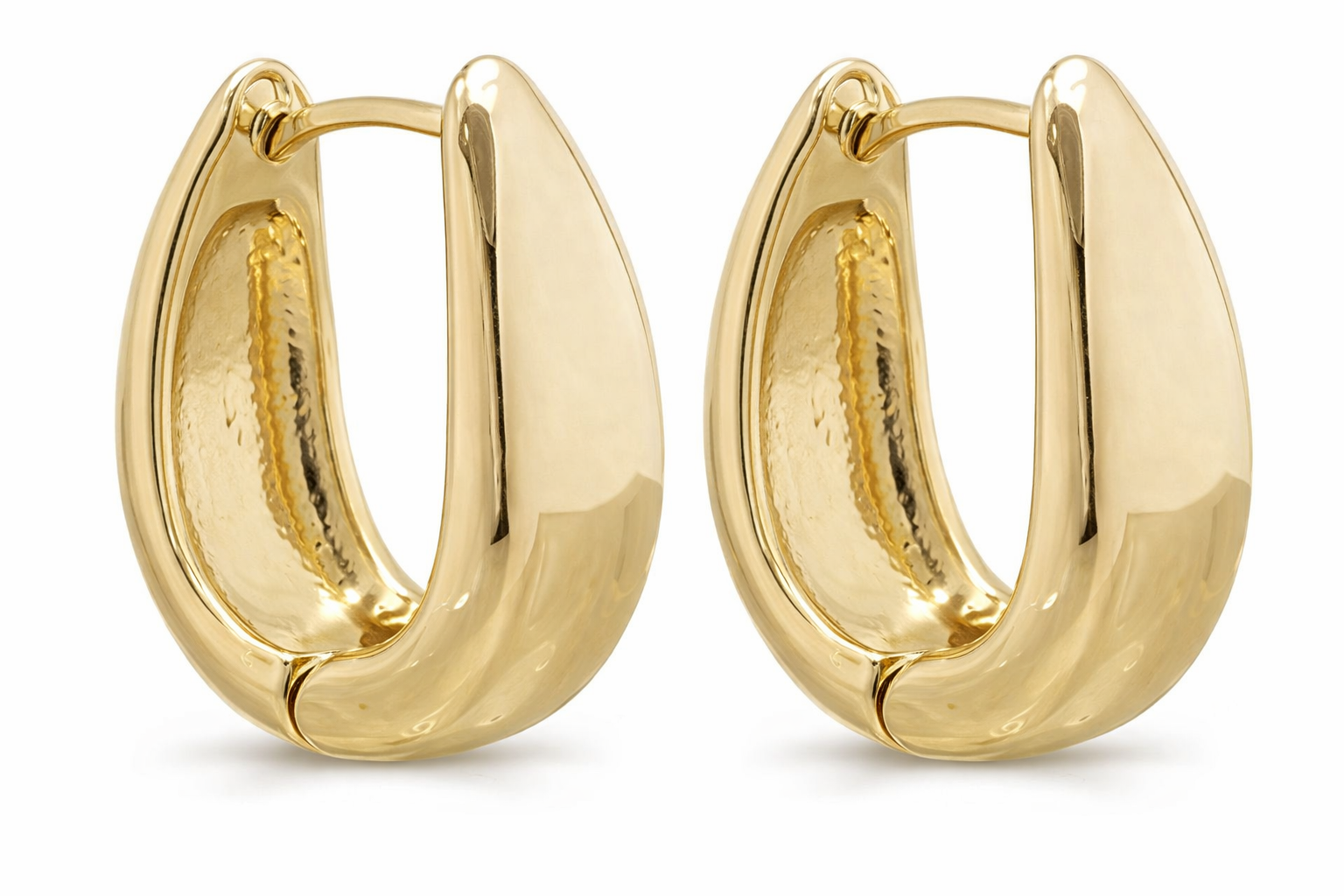 Gold hoop earrings for women by Erin Metis, showing close-up of shiny, circular earrings on model&