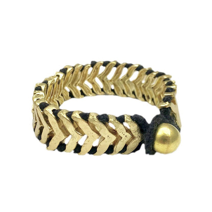 Ariel Rina Temple bracelet featuring a gold and black cuff design with intricate patterns and a sleek, modern style.