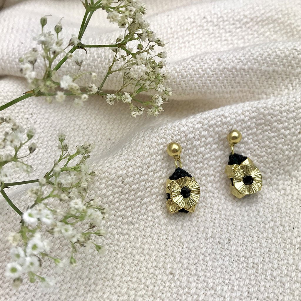 Gold fair trade Keya Flower earrings by Ariel featuring intricate flower-shaped design and elegant gold finish.