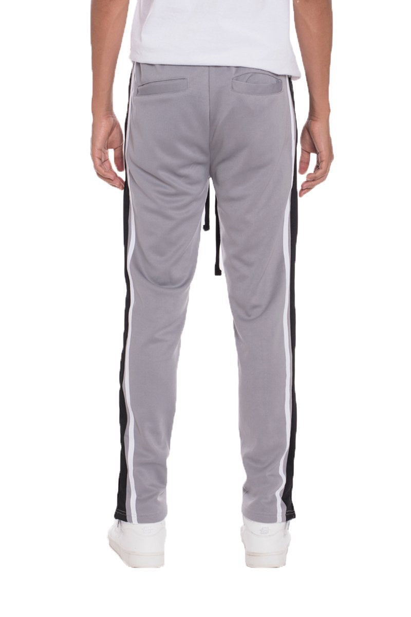 Grey striped Lime Milo track pants with a relaxed fit, featuring elastic waistband and cuffed ankles.