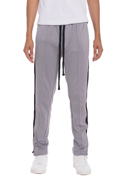 Grey Lime Milo striped track pants with elastic waistband and tapered fit, perfect for casual wear and athletic activities.