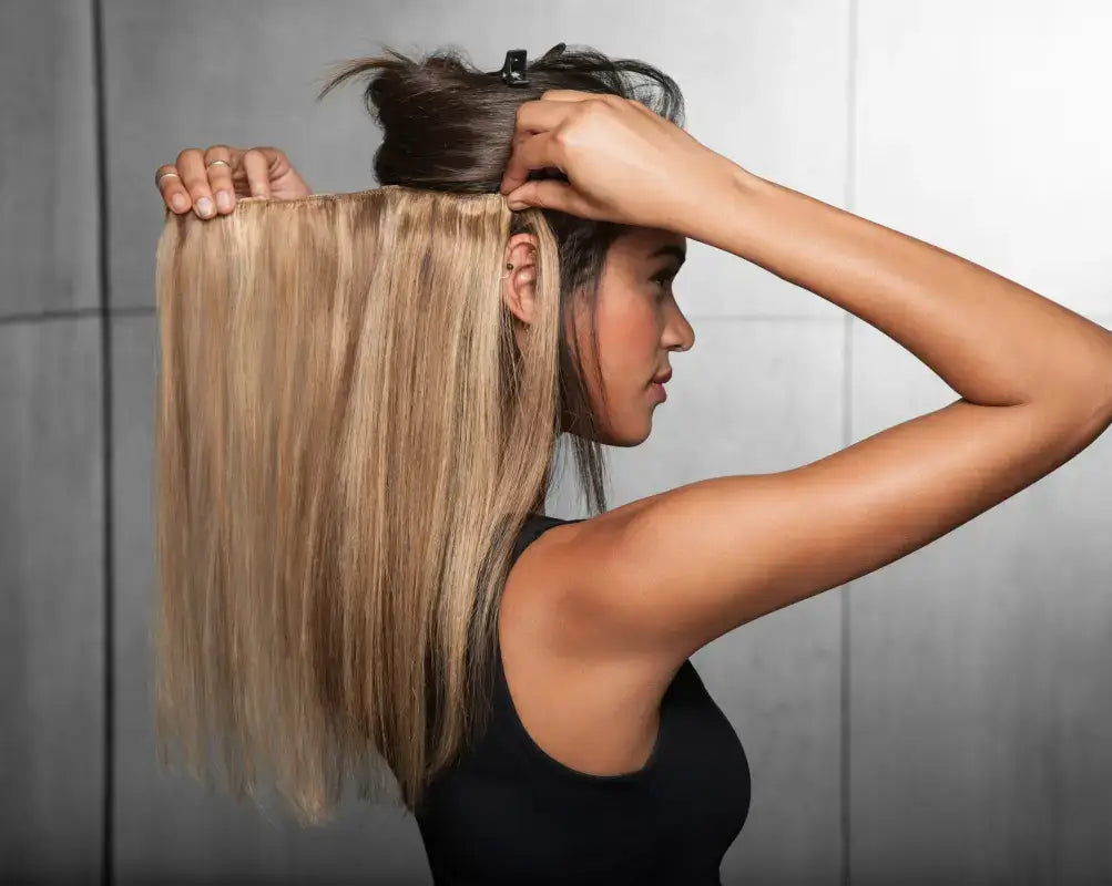 Three Peach Clymene Hairdo 18-inch human hair highlight clip-in extensions on a model, showcasing natural textured hair.