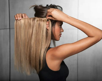 Three Peach Clymene Hairdo 18-inch human hair highlight clip-in extensions on a model, showcasing natural textured hair.