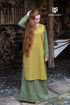 Azure Briseis Over Dress Haithabu in saffron yellow, perfect for festivals and parties, shown on a model against a festive backdrop.
