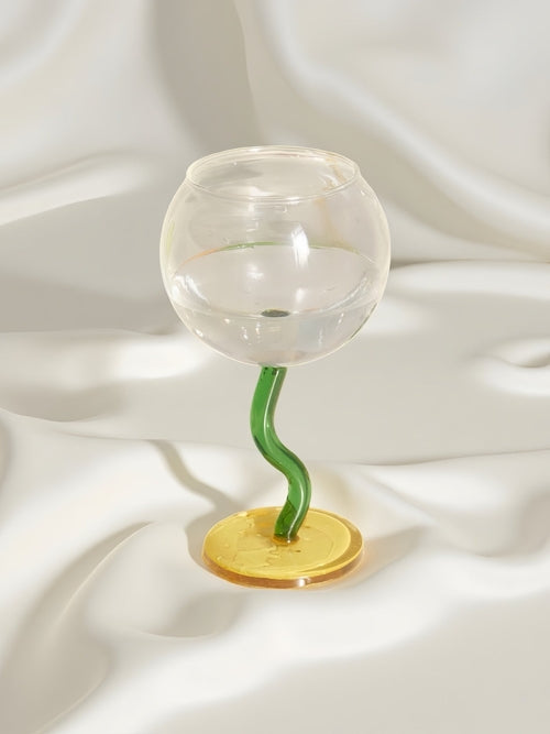 Handblown bubble wine glass with a whimsical retro design, featuring a wavy stem, perfect for eclectic home decor.