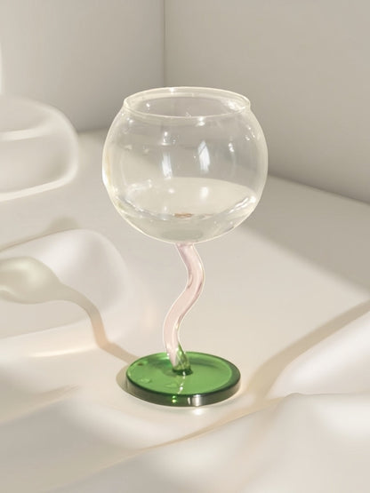 Handblown bubble wine glass with a wavy stem, retro whimsical design, perfect for eclectic home decor by Inspecial Home.