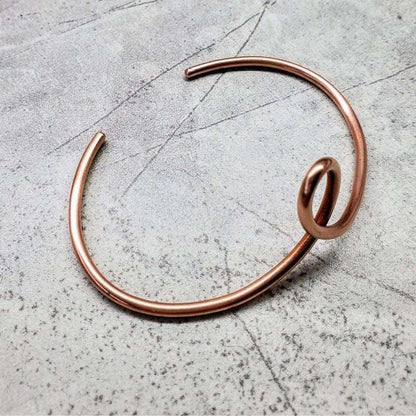 Handmade sculpted copper teardrop bangle bracelet with intricate design, crafted by Blue Crius.