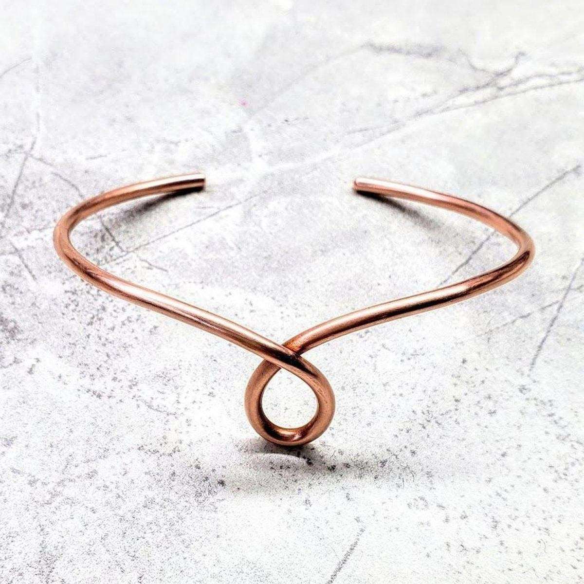 Handmade sculpted copper teardrop bangle bracelet by Blue Crius, featuring intricate design and polished copper finish.