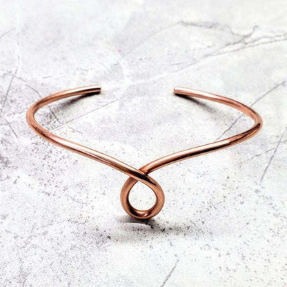 Handmade sculpted copper teardrop bangle bracelet by Blue Crius, featuring intricate design and polished copper finish.