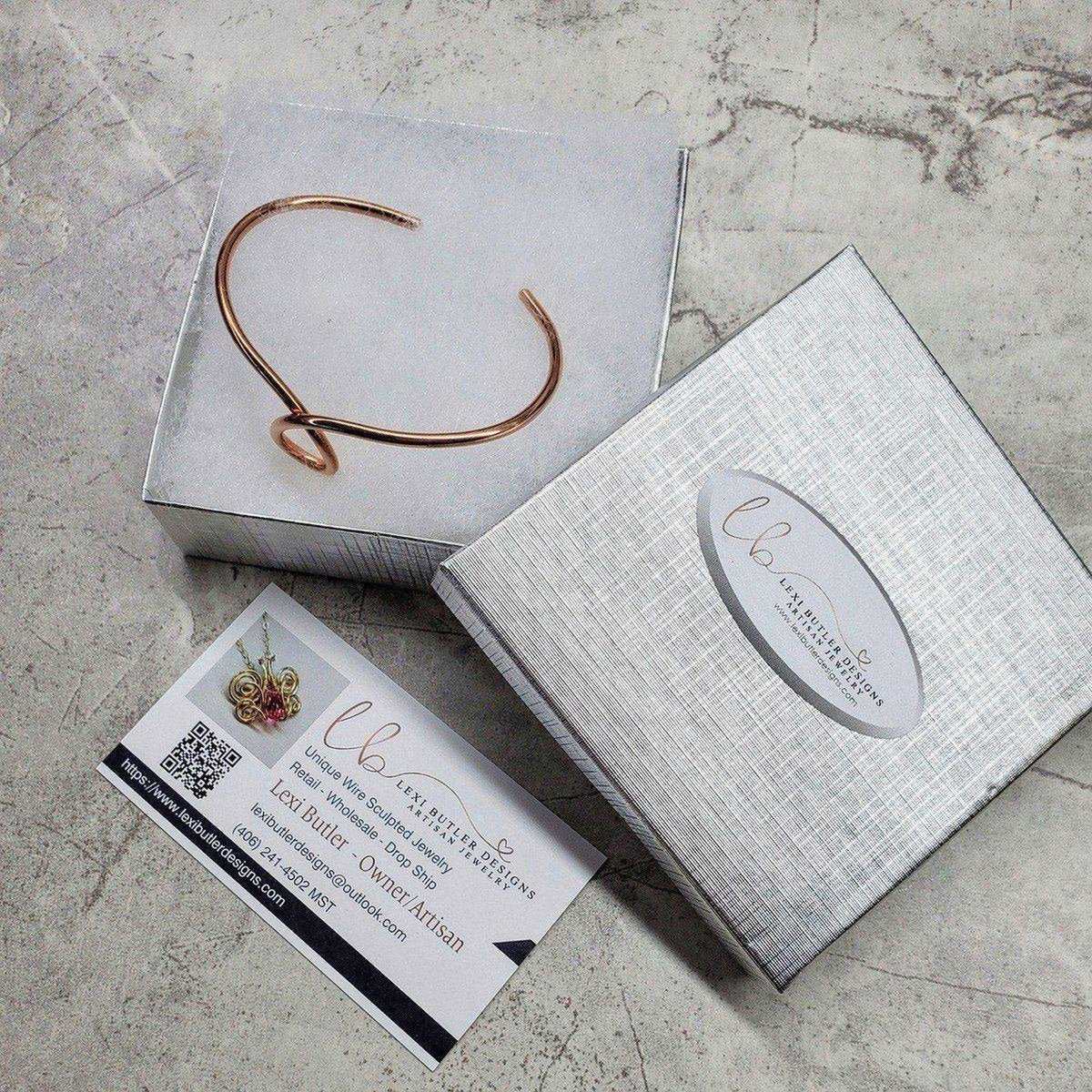 Handmade sculpted copper teardrop bangle bracelet from Blue Crius, featuring intricate craftsmanship and unique teardrop design.