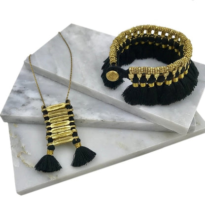 Ariel Kyra Tassel Bracelet featuring handmade tassels and beads, showcasing vibrant colors on a delicate bracelet.